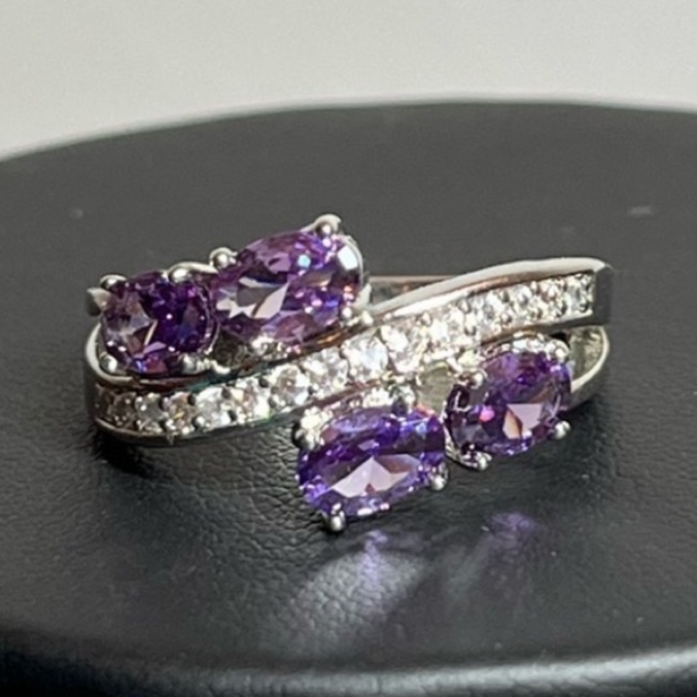 Silver tone statement ring with purple accents
Size 8